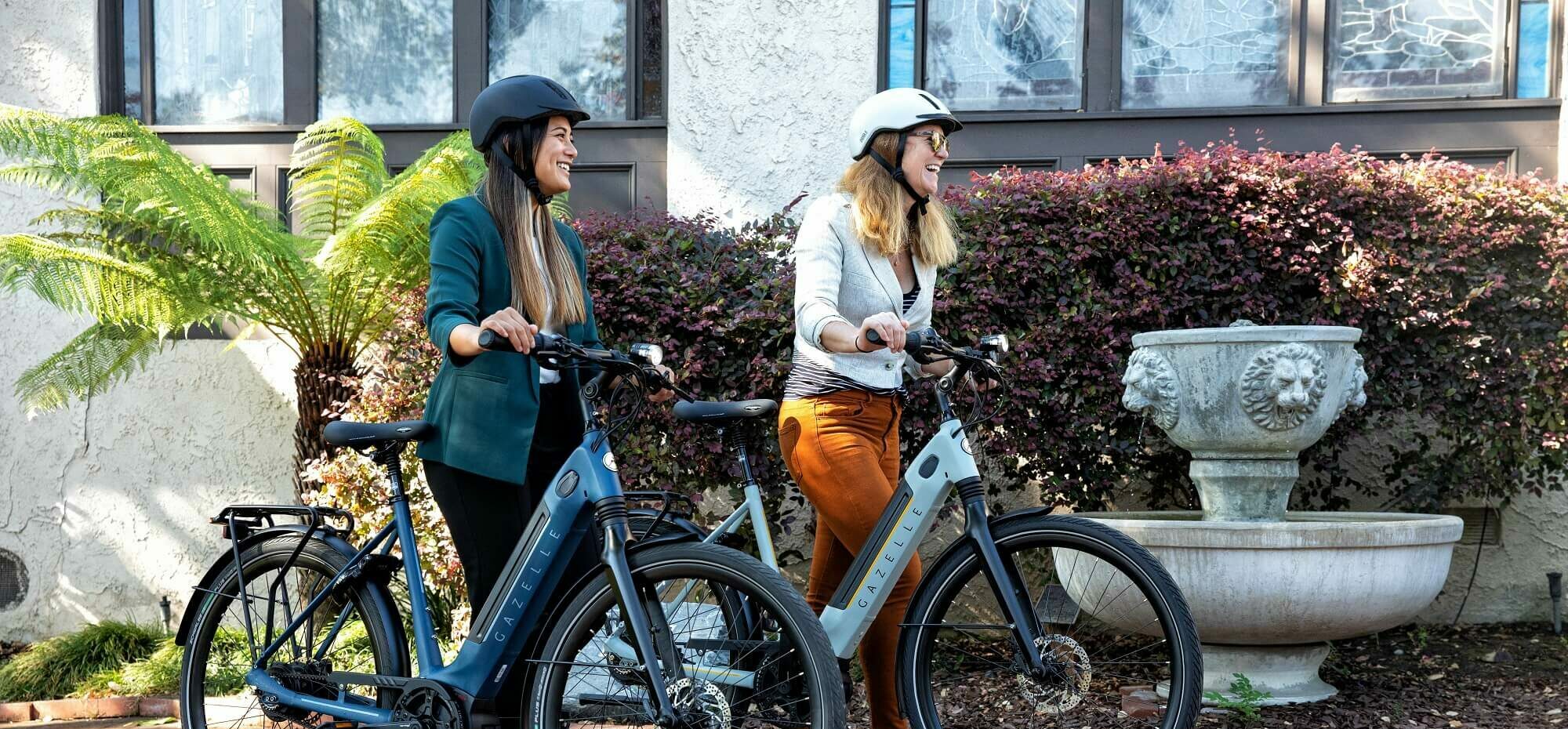 To kvinder med hjelm og cykel